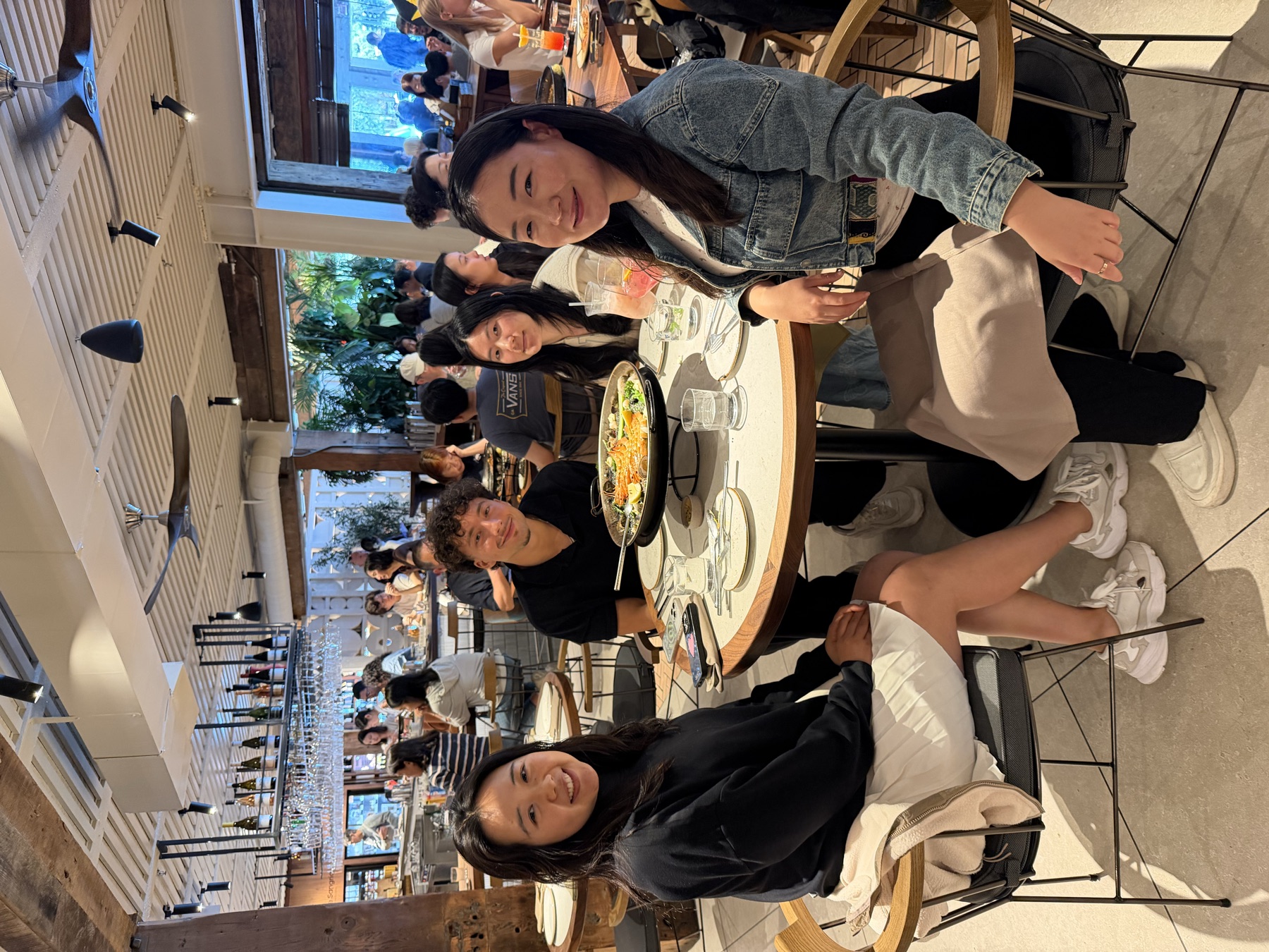 Four members of the Nyotta team around a table at a restaurant, a shared paella between them.